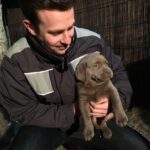 Hundetrainer und RUDEL.-Gründer Tim Matschkowski mit Welpe und eigenem Hund Piet